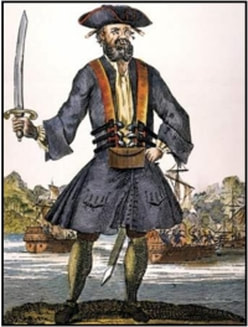 Pirate with a sword standing on a rock